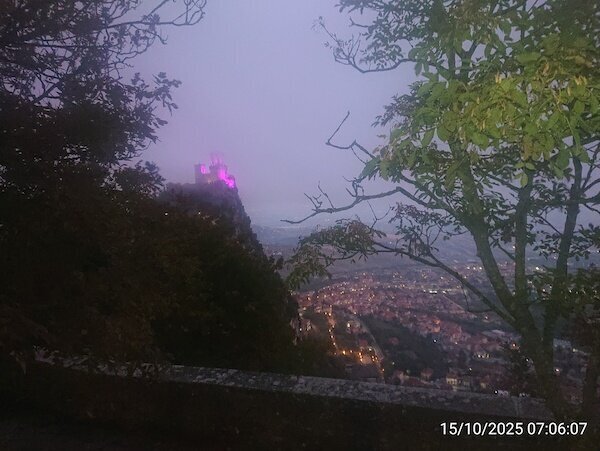 Burgturm auf Bergspitze und Blick auf Ort darunter